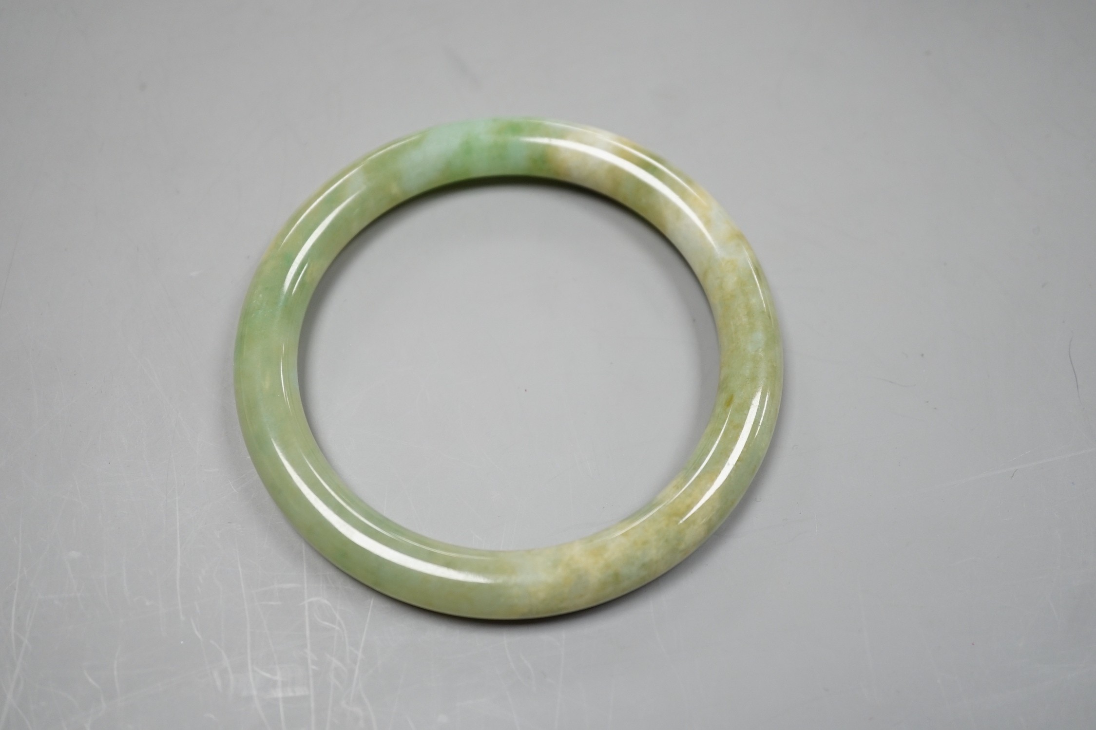 A green hardstone bangle.